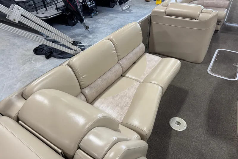 Slide: The Image of Luxurious beige seating on a 2012 Bennington 25 QCW pontoon boat interior. - 12