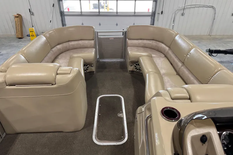 Slide: The Image of Luxurious interior of a 2012 Bennington 25 QCW pontoon boat with beige seating. - 13