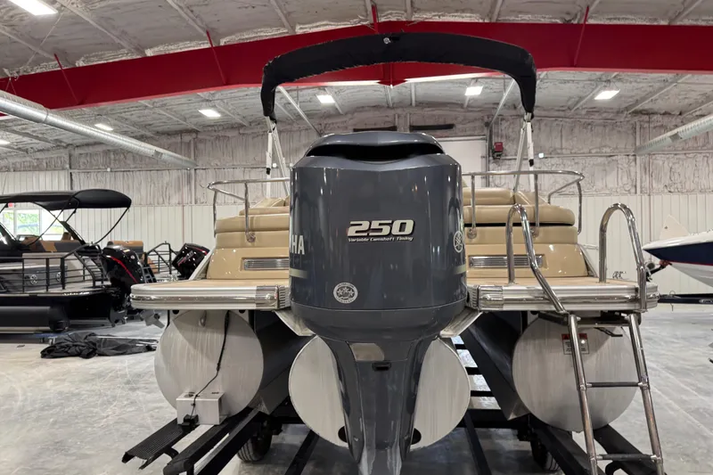 Slide: The Image of 2012 Bennington 25 QCW pontoon boat with Yamaha 250 engine in indoor storage. - 5