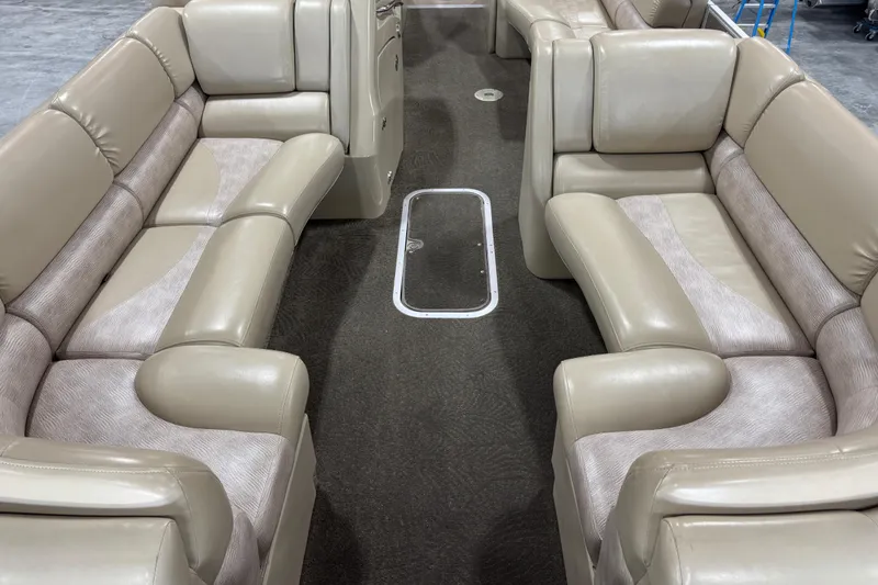Slide: The Image of Interior of a 2012 Bennington 25 QCW pontoon boat with beige seating. - 7