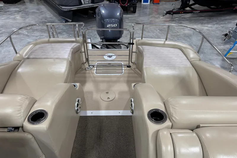 Slide: The Image of 2012 Bennington 25 QCW pontoon boat interior with beige seating and Yamaha 250 outboard motor. - 8