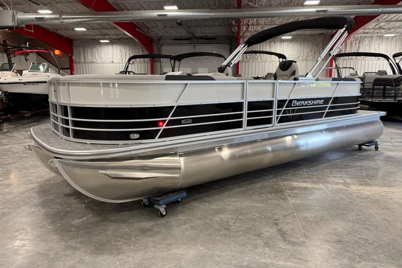 The Image of 2026 Berkshire 24 RFX LE pontoon boat in showroom, featuring sleek design and modern amenities. - 1