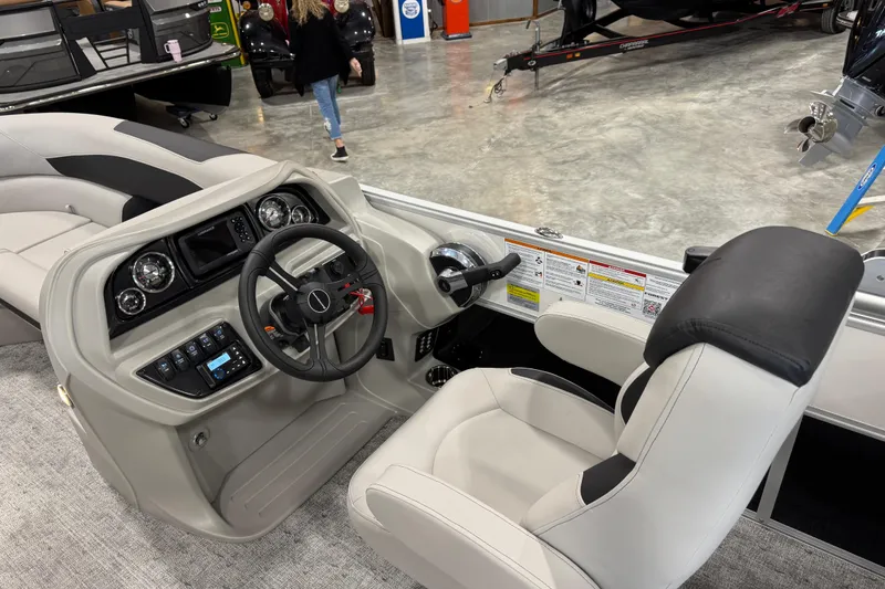 Slide: The Image of Interior view of 2026 Berkshire 24 RFX LE boat, featuring modern steering console and seating. - 12