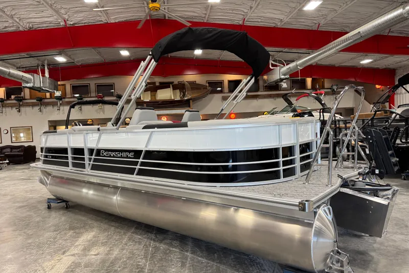 Slide: The Image of 2026 Berkshire 24 RFX LE pontoon boat displayed indoors with sleek design and modern features. - 5
