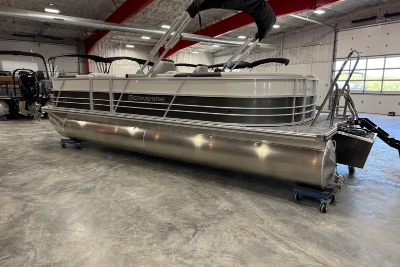 Slide: The Image of 2026 Berkshire 24RFX LE pontoon boat in a spacious indoor showroom. - 3