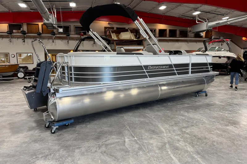 Slide: The Image of 2026 Berkshire 24RFX LE pontoon boat displayed indoors, showcasing sleek design and modern features. - 6