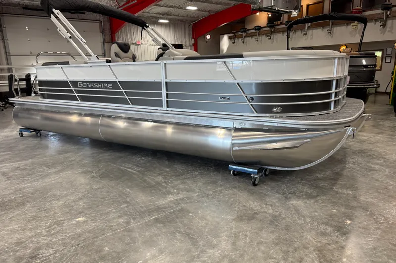 Slide: The Image of 2026 Berkshire 24RFX LE pontoon boat in a showroom, showcasing sleek design and modern features. - 7