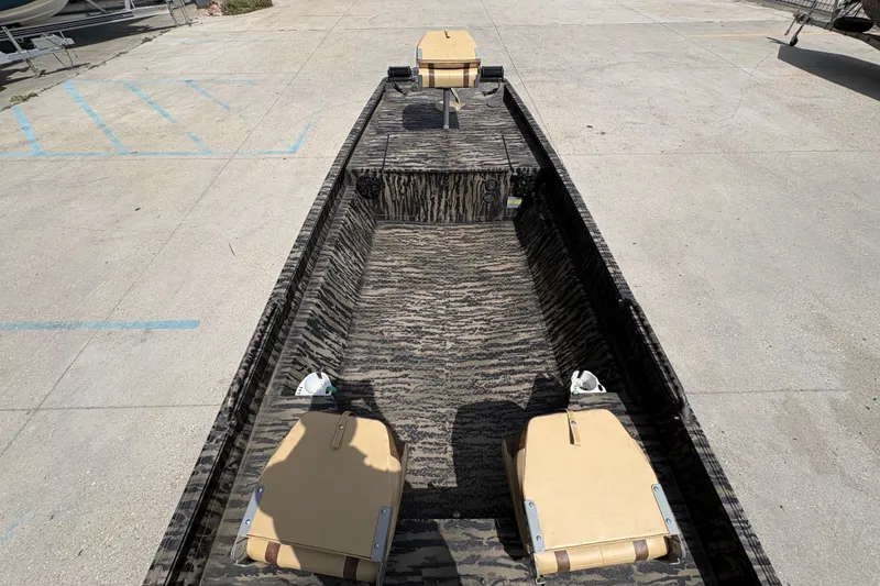 Slide: The Image of 2022 Edge Duck Boats HPSD 1656DB with camouflage interior, parked on concrete surface. - 11