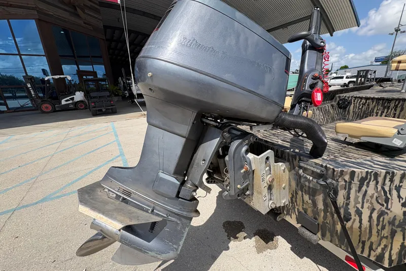 Slide: The Image of 2022 Edge Duck Boats HPSD 1656DB with outboard motor, parked outdoors. - 18