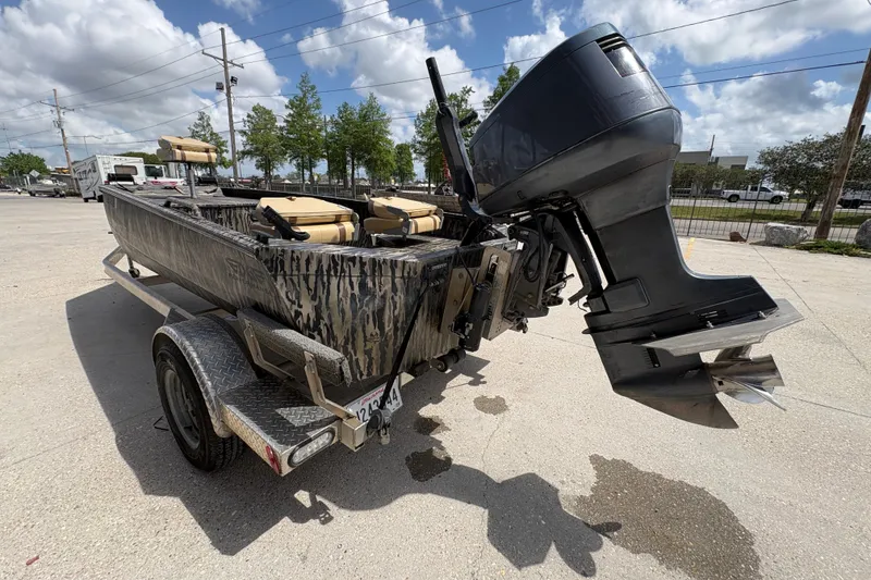 Slide: The Image of 2022 Edge Duck Boats HPSD 1656DB on trailer, featuring camo design and powerful outboard motor. - 5