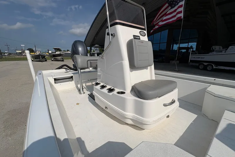 Slide: The Image of 2021 Avid 21 FS boat with seating, docked near American flag. - 12