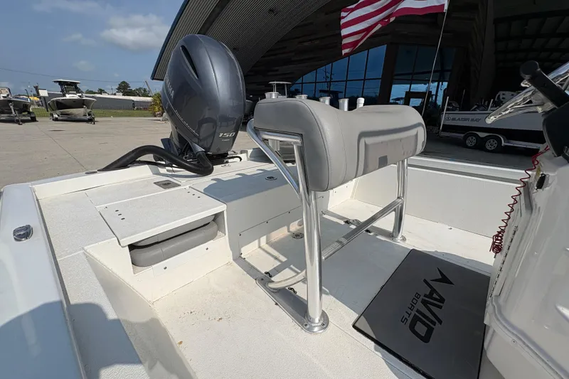 Slide: The Image of 2021 Avid 21 FS boat with Yamaha 150 engine, docked near showroom. - 13