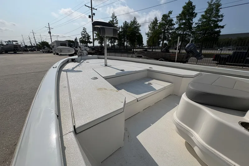 Slide: The Image of Avid 21 FS 2021 boat deck with seating and storage, parked outdoors. - 17