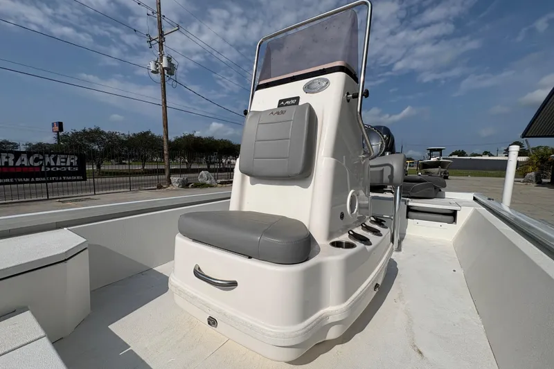 Slide: The Image of 2021 Avid 21 FS boat console with seating, showcased outdoors under a blue sky. - 18