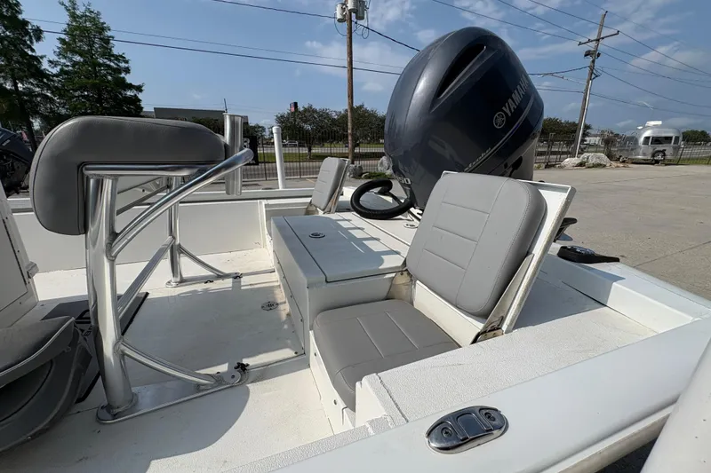 Slide: The Image of 2021 Avid 21 FS boat interior with Yamaha engine, featuring gray seating and console. - 22
