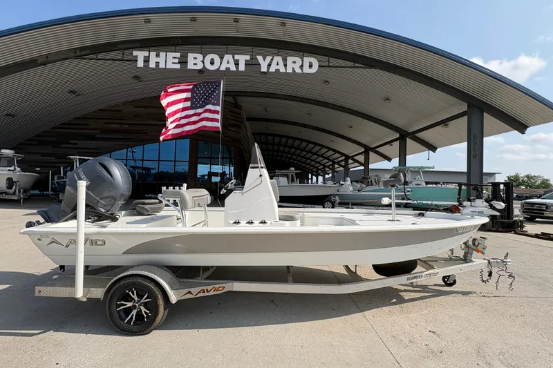 Slide: The Image of Avid 21 FS boat from 2021 on trailer at The Boat Yard, with American flag. - 3