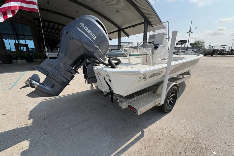 Slide: The Image of 2021 Avid 21 FS boat with Yamaha engine on trailer, parked outdoors. - 4