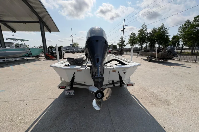 Slide: The Image of 2021 Avid 21 FS boat with outboard motor in a parking area. - 5