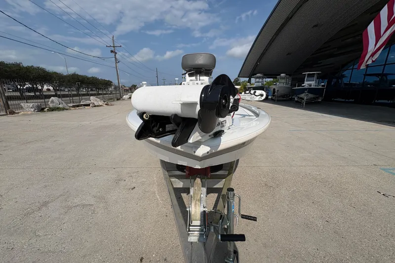 Slide: The Image of Avid 21 FS boat from 2021 on a trailer, parked outdoors under a clear sky. - 9