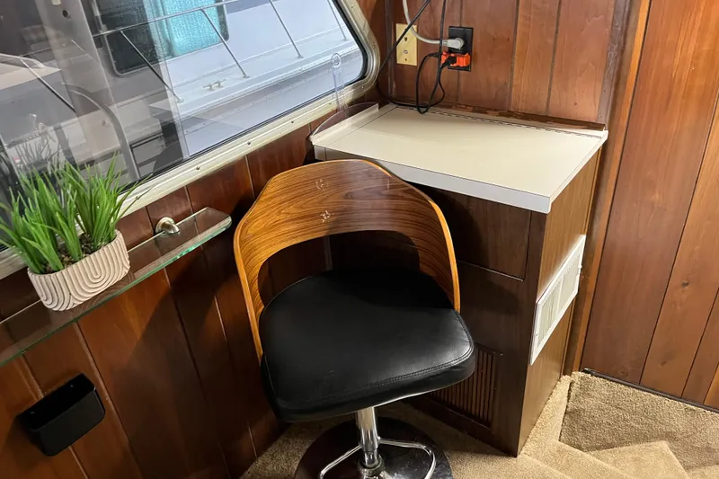 Slide: The Image of Wood-paneled interior with a modern chair, small desk, and potted plant on a 1990 Gibson 44. - 10