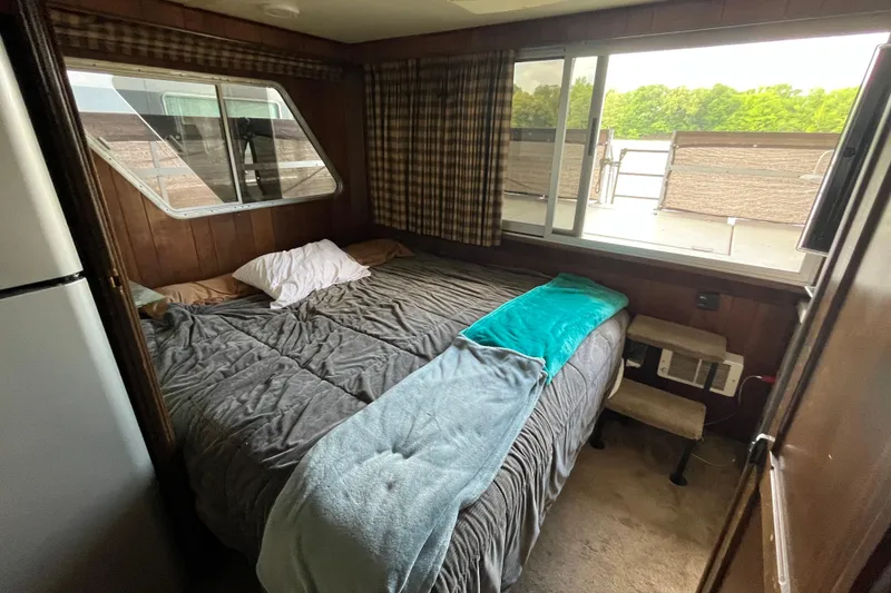 Slide: The Image of Cozy bedroom in 1990 Gibson 44 boat with large windows and plaid curtains. - 19