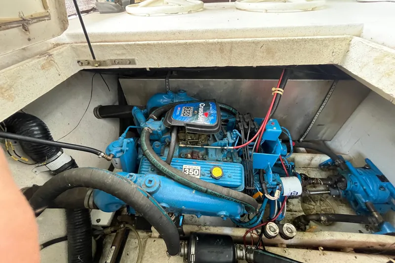 Slide: The Image of Engine compartment of a 1990 Gibson 44 boat featuring a Crusader Marine 350 engine. - 34