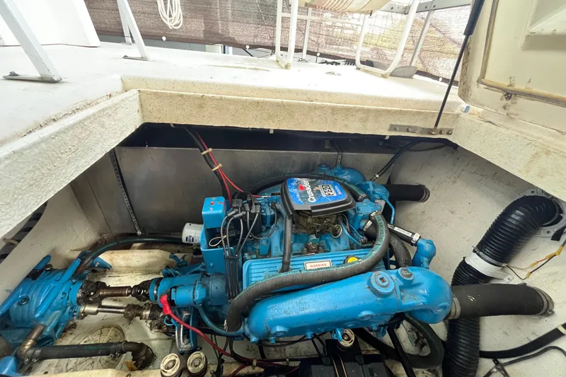 Slide: The Image of Engine compartment of a 1990 Gibson 44 boat, featuring a Crusader 350 engine. - 35