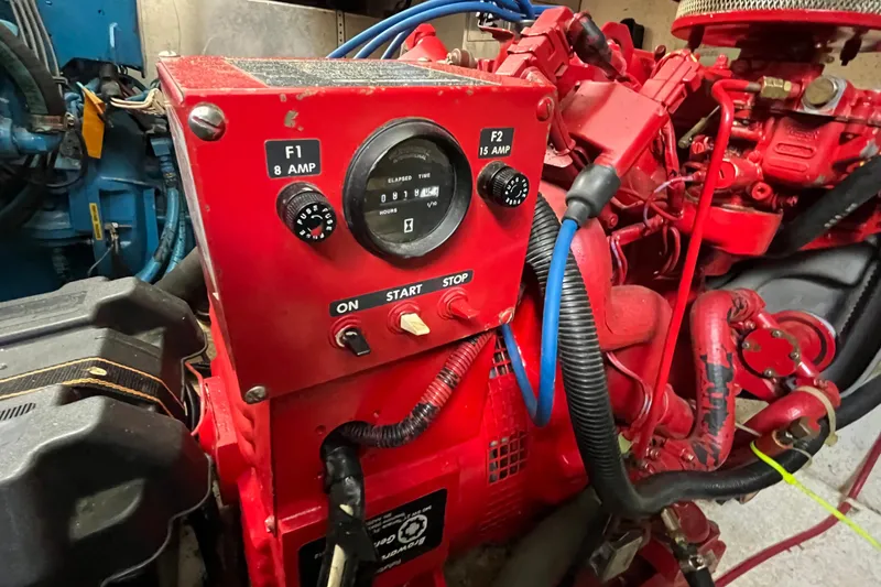 Slide: The Image of Red Gibson 44 engine control panel from 1990 with gauges and wiring. - 37