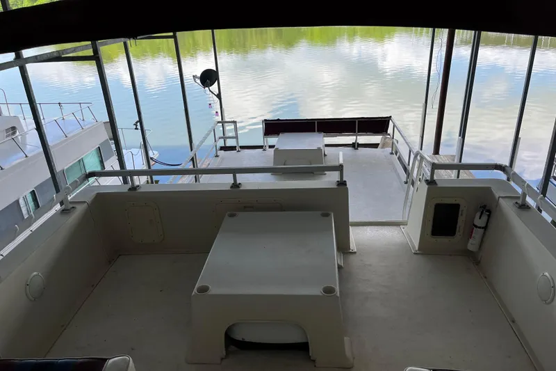 Slide: The Image of Upper deck of a 1990 Gibson 44 boat overlooking calm waters. - 43
