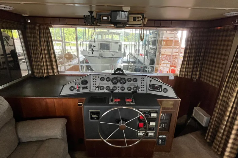 Slide: The Image of Interior helm of a 1990 Gibson 44 boat with vintage controls and steering wheel. - 6