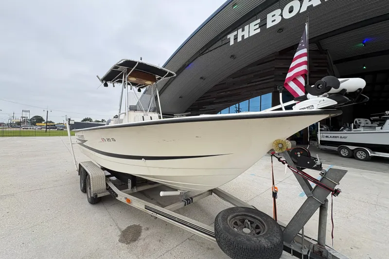 Slide: The Image of 1998 Hydra-Sports 22 Ocean CC boat on trailer, parked outside a large building. - 11