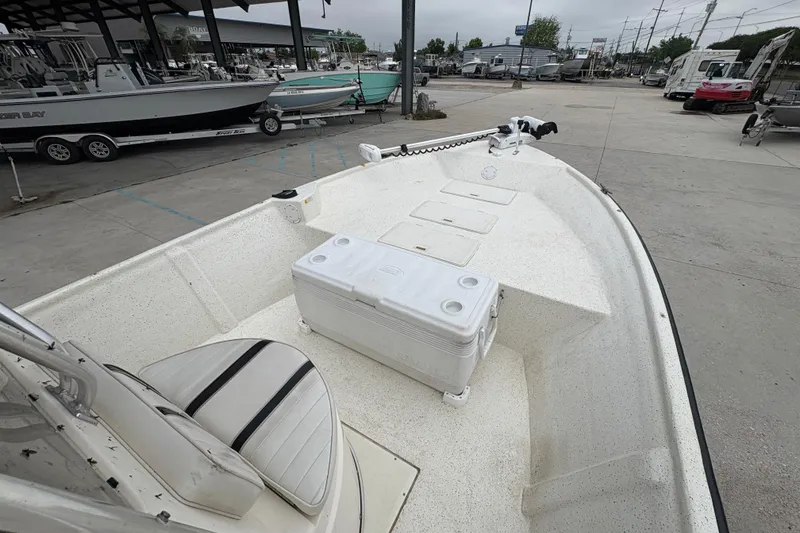 Slide: The Image of 1998 Hydra-Sports 22 Ocean CC boat interior with seating and cooler, parked in a marina. - 14