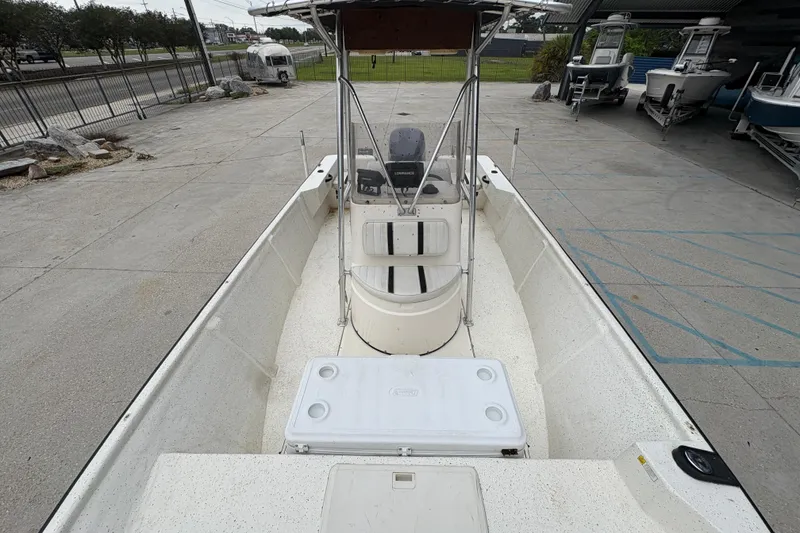 Slide: The Image of 1998 Hydra-Sports 22 Ocean CC boat with center console and T-top in a parking area. - 17