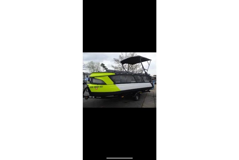 The Image of 2023 Sea-Doo Switch Cruise 21 pontoon boat with canopy, parked on trailer. - 1