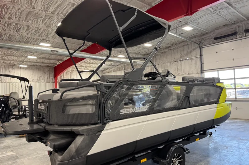 Slide: The Image of 2023 Sea-Doo Switch Cruise 21 pontoon boat in a showroom, featuring a sleek design. - 12