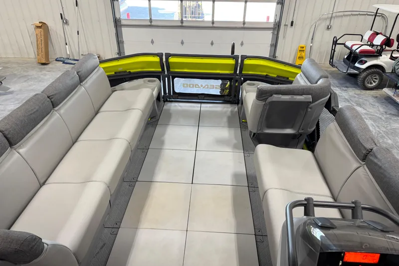 Slide: The Image of 2023 Sea-Doo Switch Cruise 21 interior with spacious seating in a garage setting. - 17