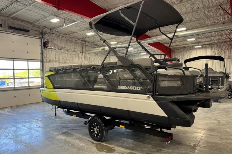 Slide: The Image of 2023 Sea-Doo Switch Cruise 21 pontoon boat in a showroom, featuring a sleek design. - 9