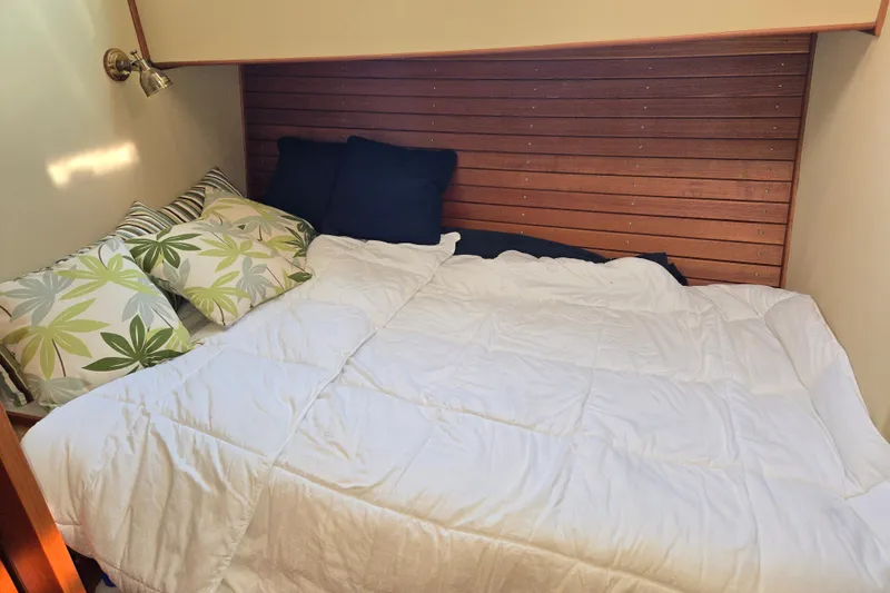 Slide: The Image of Cozy cabin bed with floral pillows on 1992 Grand Banks 46 Classic yacht. - 11