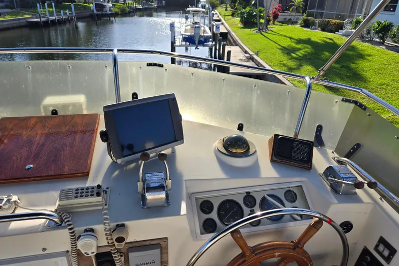 Slide: The Image of Helm of 1992 Grand Banks 46 Classic yacht with navigation equipment and steering wheel. - 12