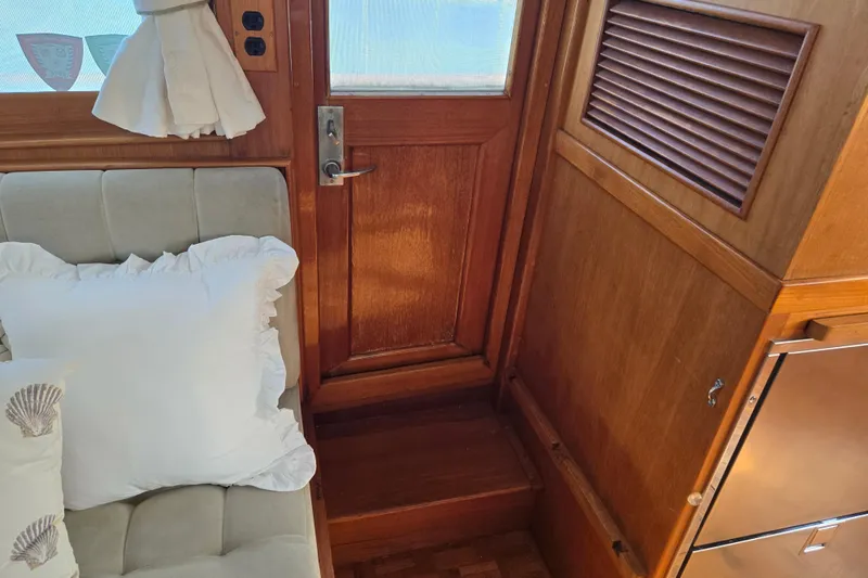Slide: The Image of Interior of 1992 Grand Banks 46 Classic yacht with wooden door and plush seating. - 18