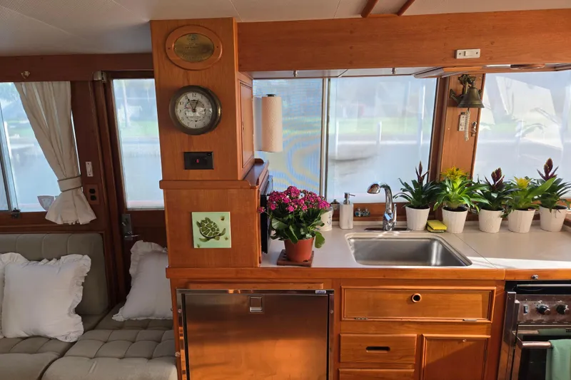 Slide: The Image of Interior of a 1992 Grand Banks 46 Classic yacht with plants and wooden cabinetry. - 23