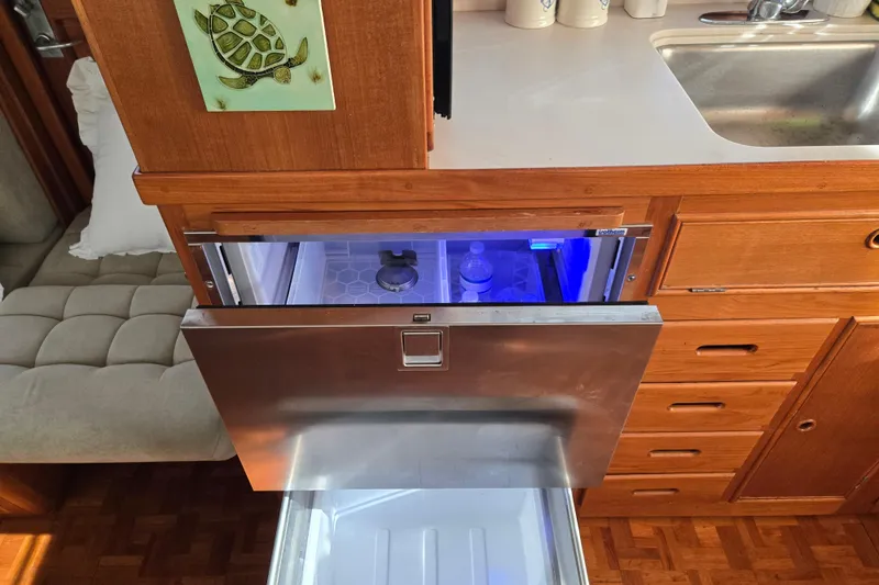 Slide: The Image of Kitchen area of a 1992 Grand Banks 46 Classic yacht with open drawer fridge. - 29
