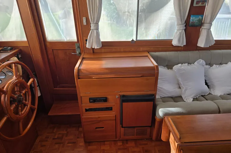 Slide: The Image of Interior of 1992 Grand Banks 46 Classic yacht with wooden helm and cozy seating area. - 30