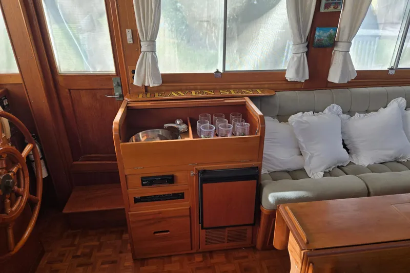 Slide: The Image of Interior of 1992 Grand Banks 46 Classic yacht with wooden cabinetry and cozy seating. - 31