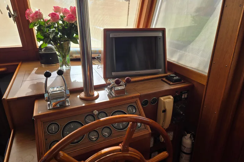 Slide: The Image of Interior helm of 1992 Grand Banks 46 Classic with wooden steering wheel and navigation equipment. - 33