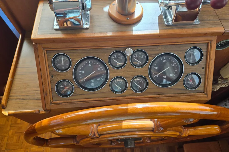 Slide: The Image of Wooden helm and gauges of a 1992 Grand Banks 46 Classic yacht. - 35
