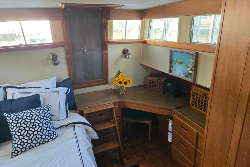 Slide: The Image of Cozy cabin interior of 1992 Grand Banks 46 Classic with desk, bed, and sunflowers. - 42