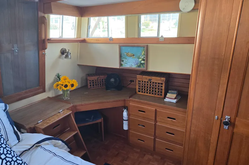 Slide: The Image of Cozy cabin interior of 1992 Grand Banks 46 Classic with wooden furnishings and sunflowers. - 44