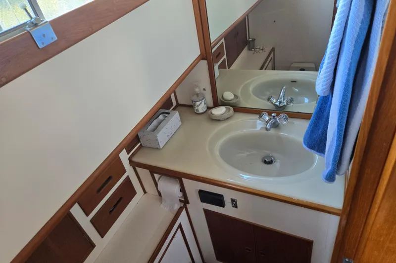 Slide: The Image of Bathroom interior of 1992 Grand Banks 46 Classic yacht with sink, mirror, and storage. - 49