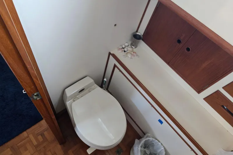 Slide: The Image of Bathroom interior of 1992 Grand Banks 46 Classic yacht with wooden cabinetry and toilet. - 50